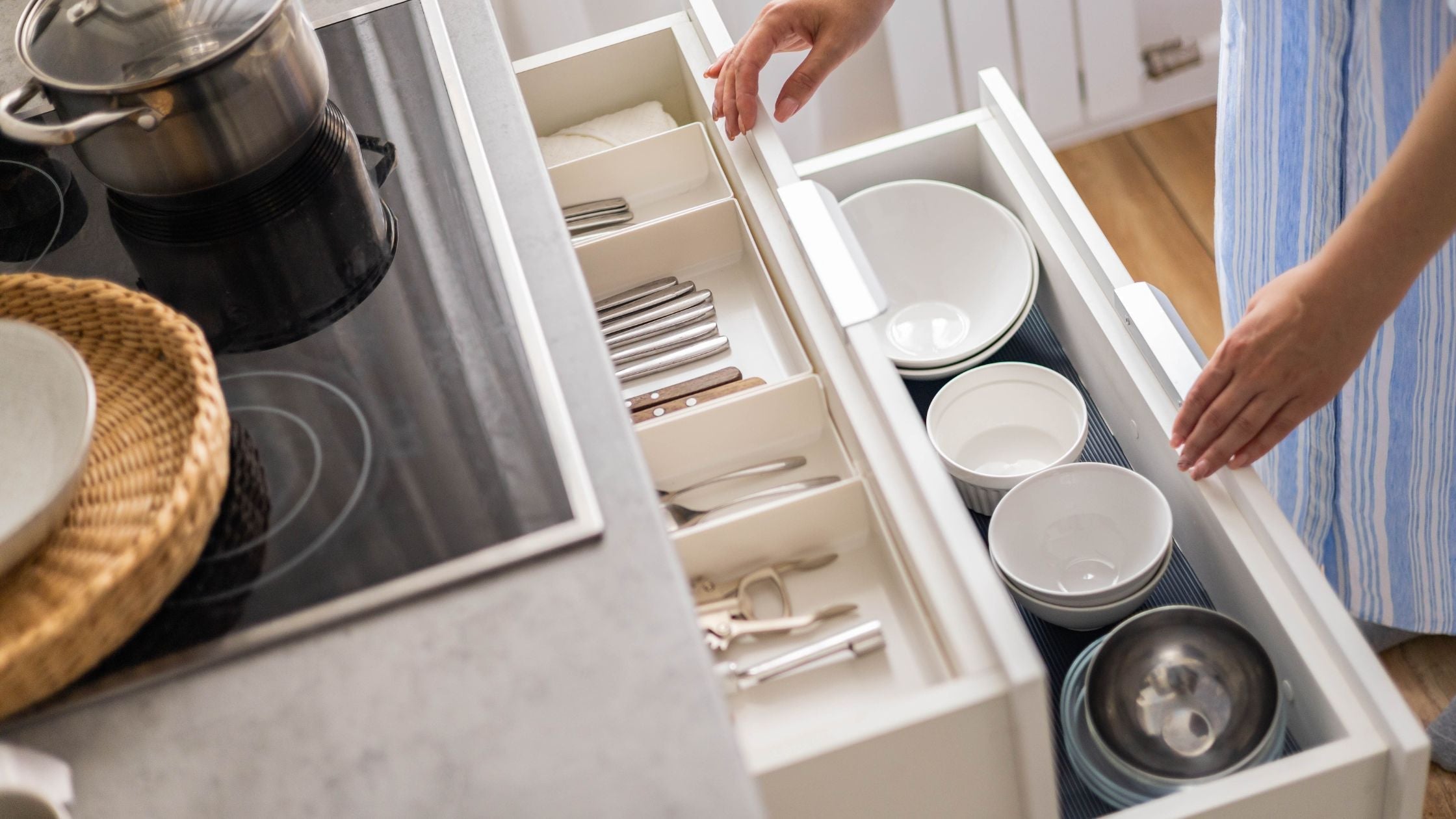 women tidyng kitchen drawer